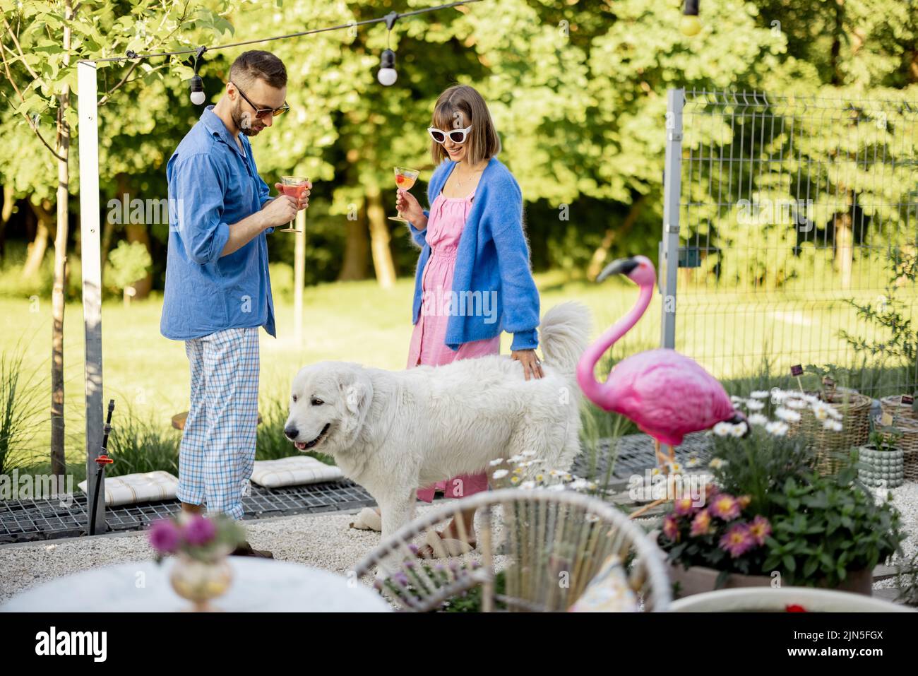 Stylish couple spend summer time at the backyard Stock Photo