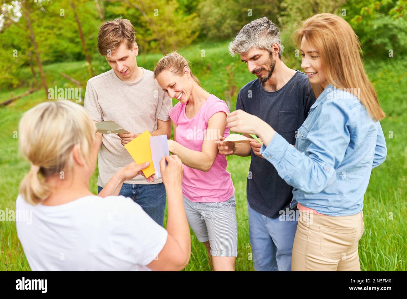 People playing creative games with colorful cards to get to know each other in the team building workshop Stock Photo