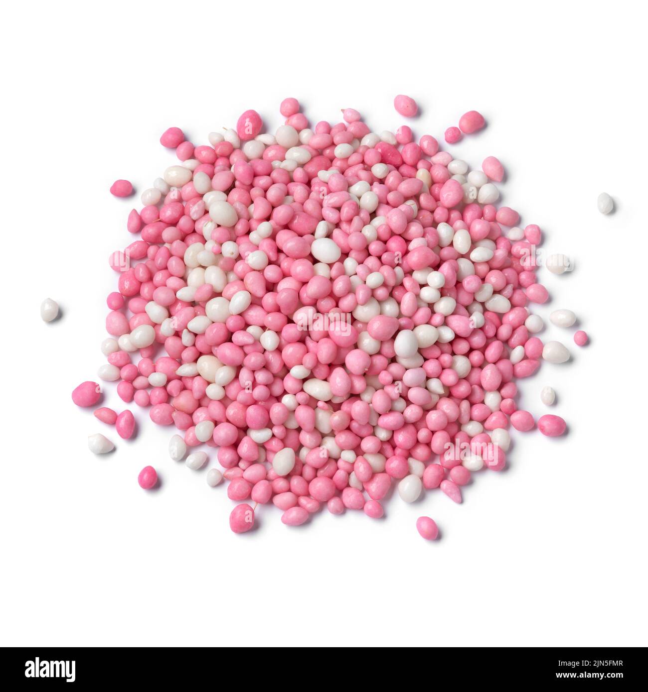 Heap of traditional Dutch pink anise sprinkles to celebrate the birth of a girl isolated on white background Stock Photo