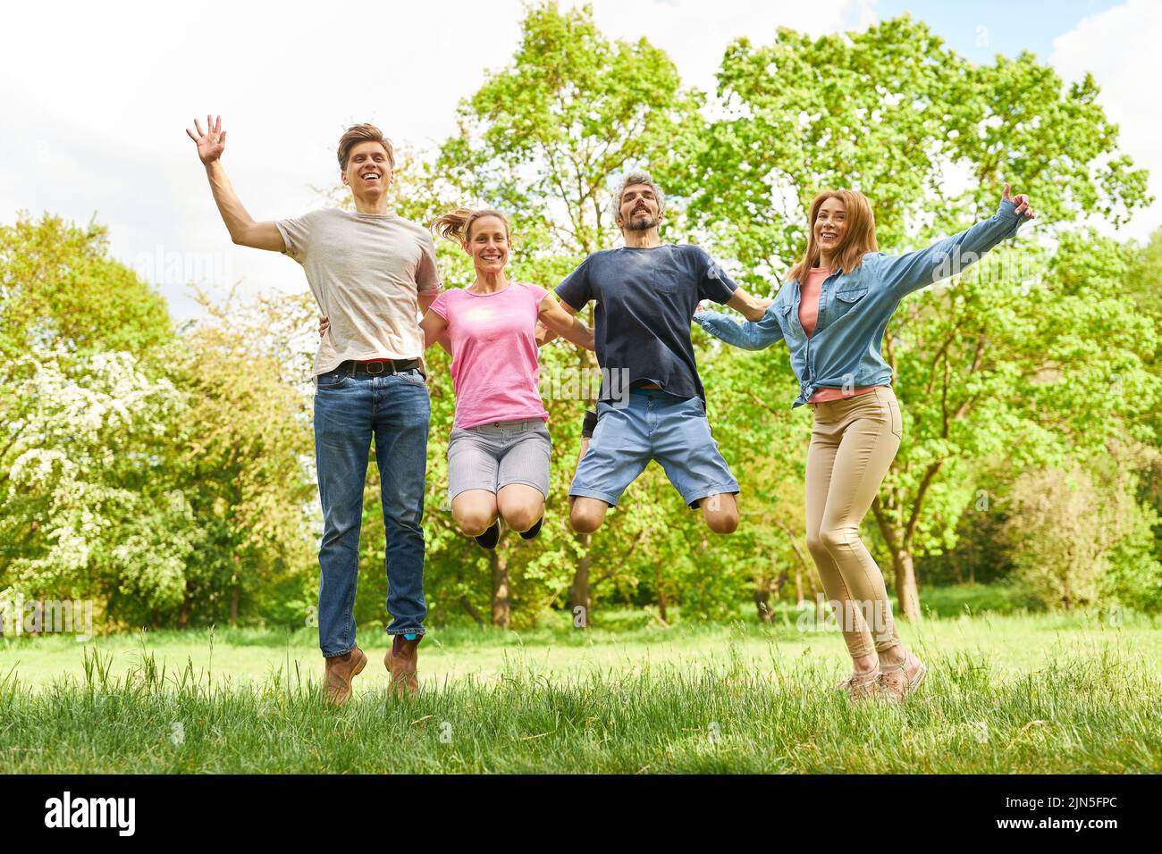 Group of young people have fun jumping in the air for joie de vivre and lightness Stock Photo