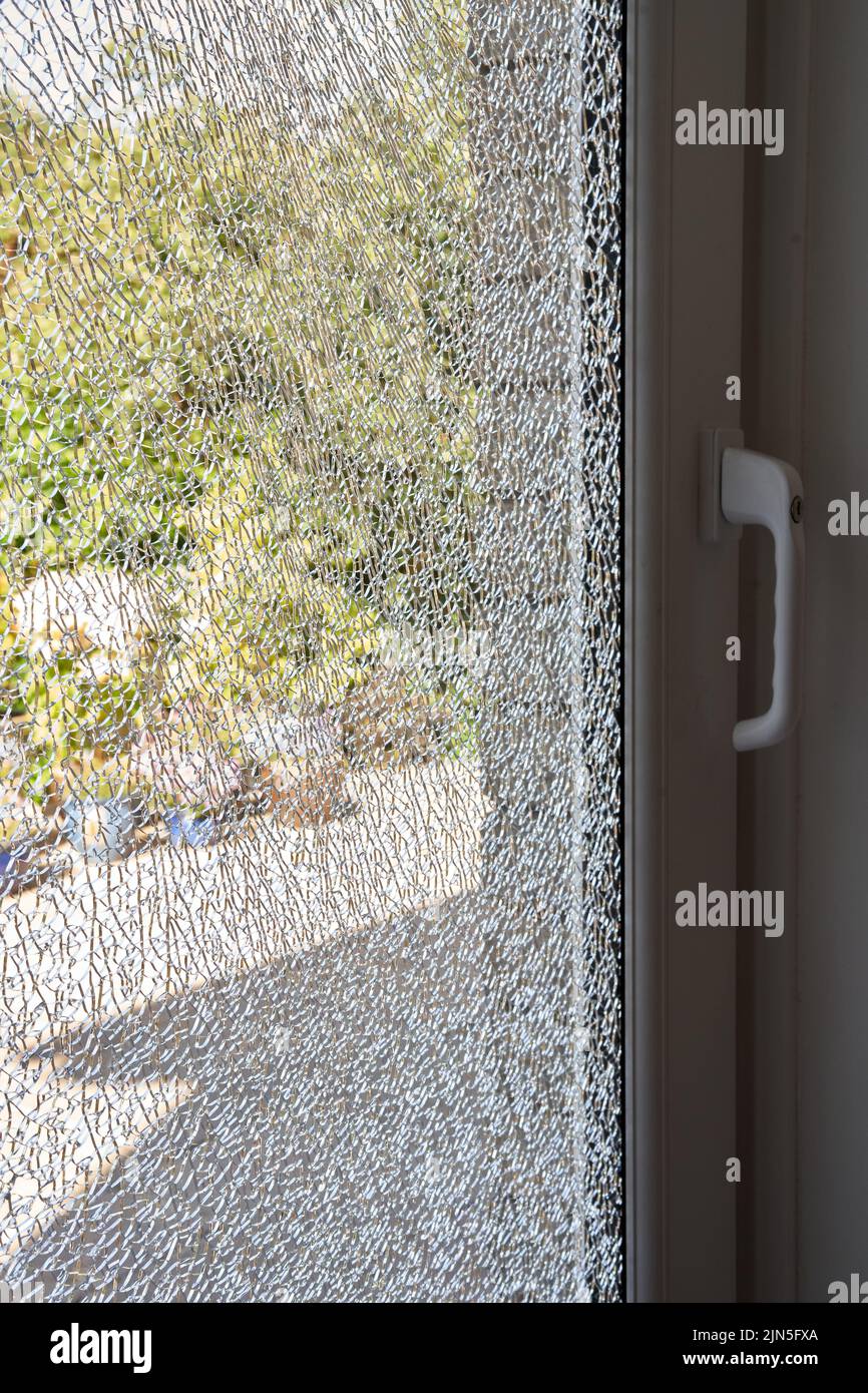 A large pane of safety glass in a patio door that has spontaneously