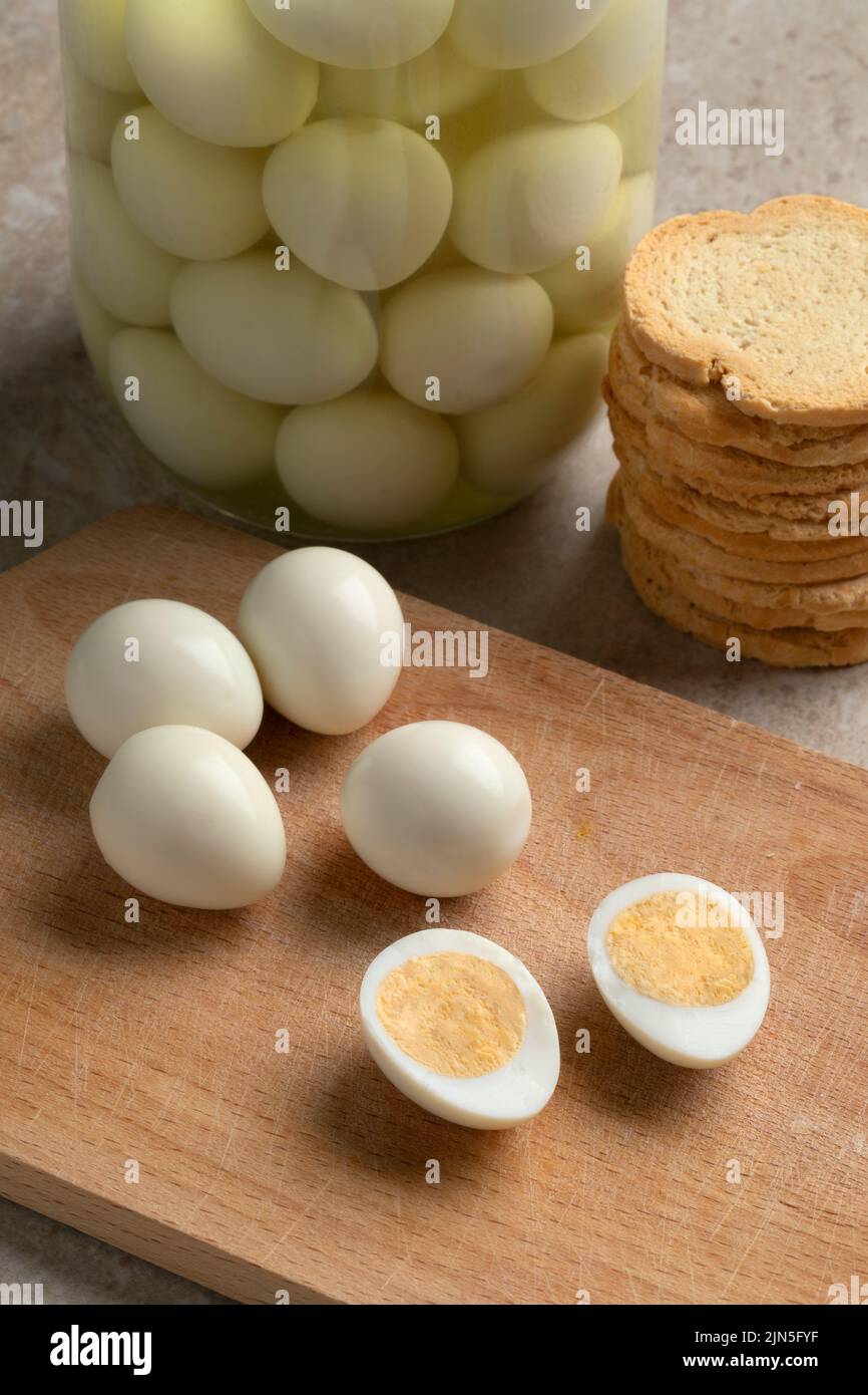 Cooked whole and halved preserved Quail eggs close up Stock Photo