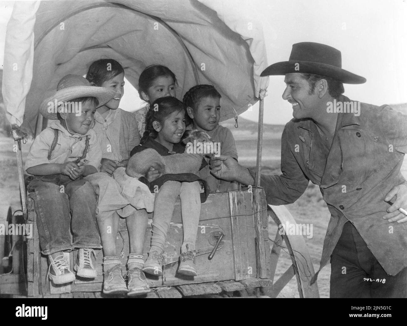 ERROL FLYNN on set location candid with Mexican children during filming ...