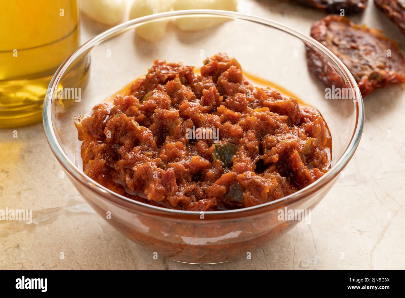 Glass bowl with sun dried tomato tapenade close up Stock Photo