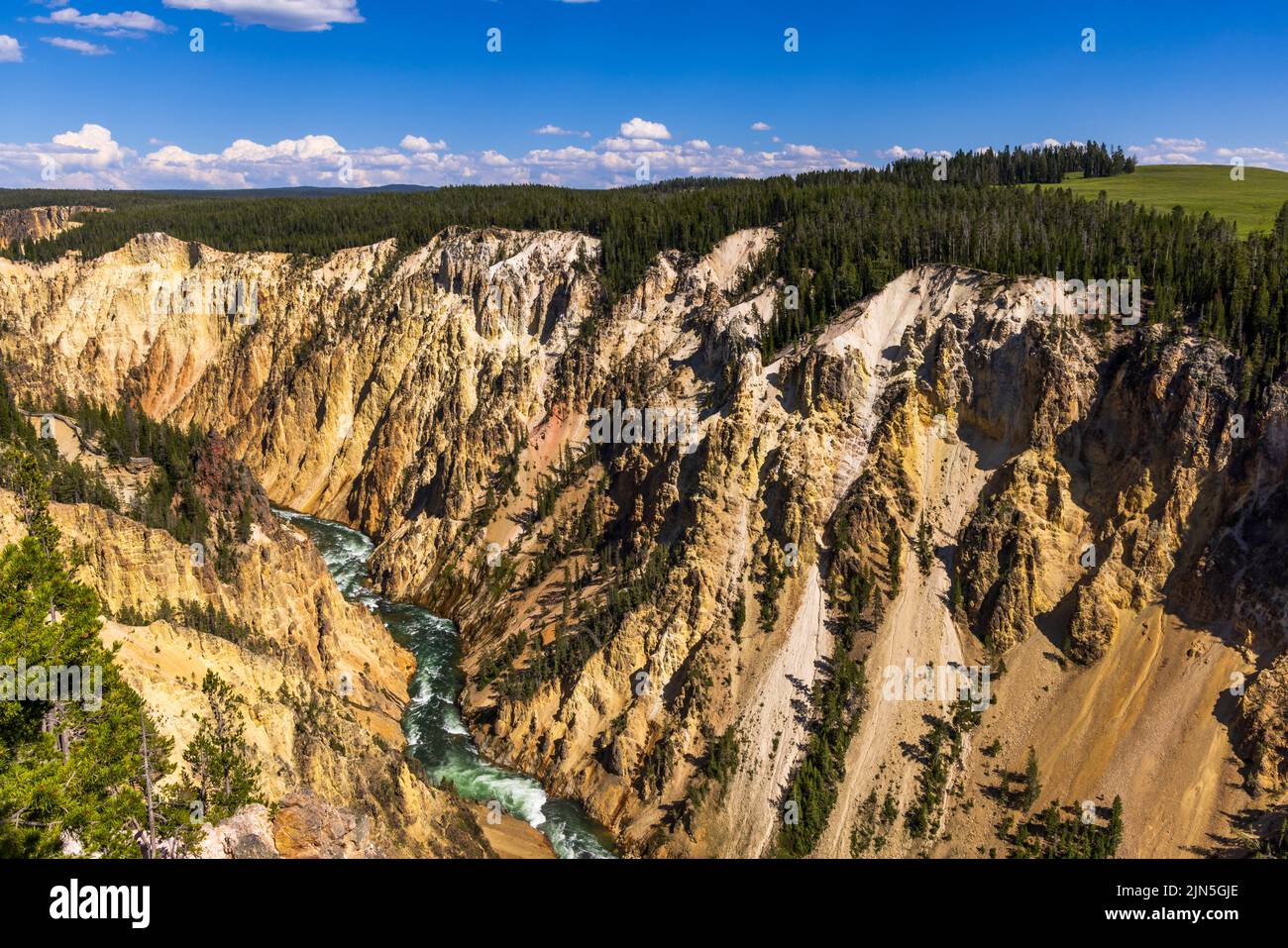 This is a view of the spectacular Grand Canyon of the Yellowstone with the Yellowstone River visible at the bottom in Yellowstone National Park, USA. Stock Photo