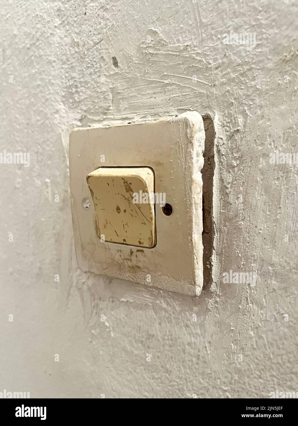 An old fashioned light switch mounted on a white wall Stock Photo Alamy