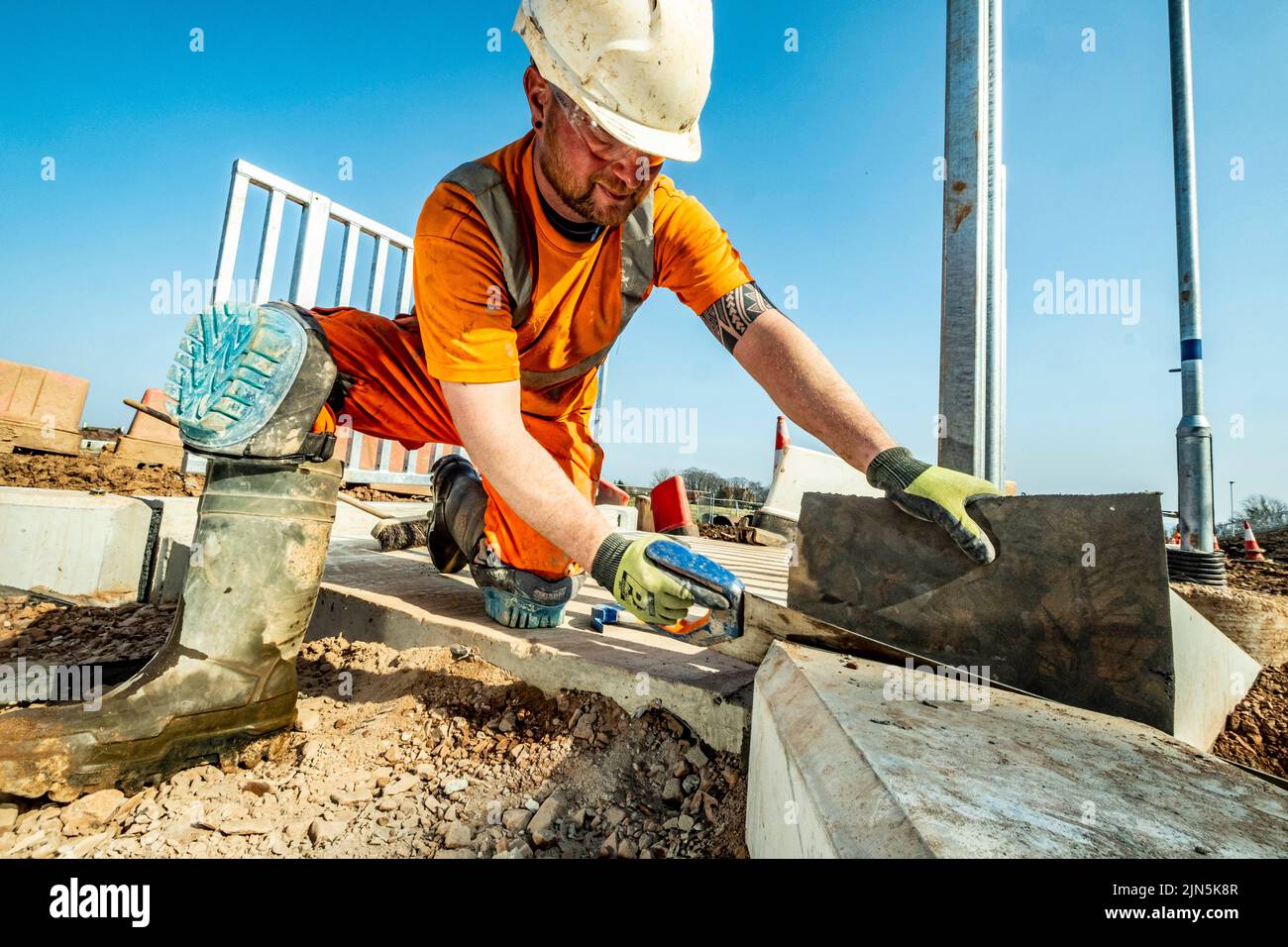 Railway workers building new railway and knocking down bridges Stock Photo