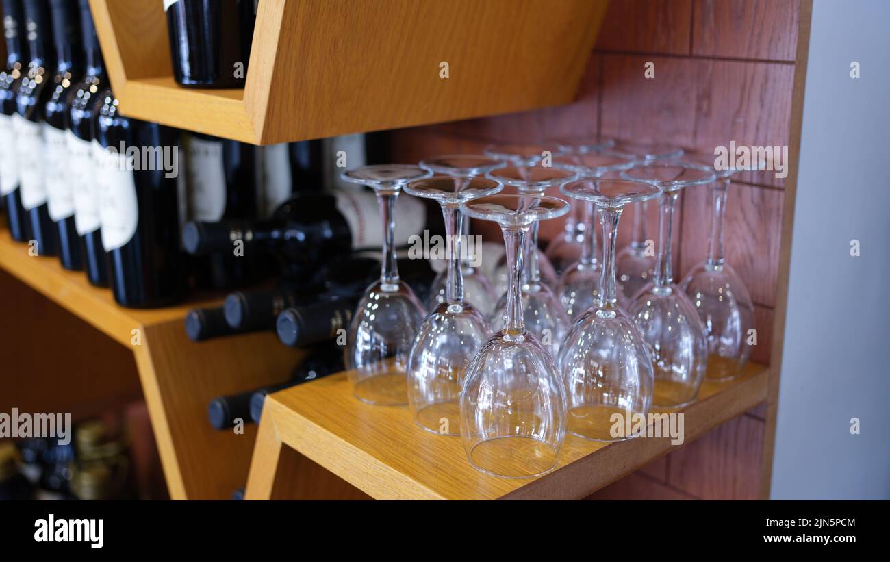 Bottles of wine wine glasses on rack Stock Photo Alamy
