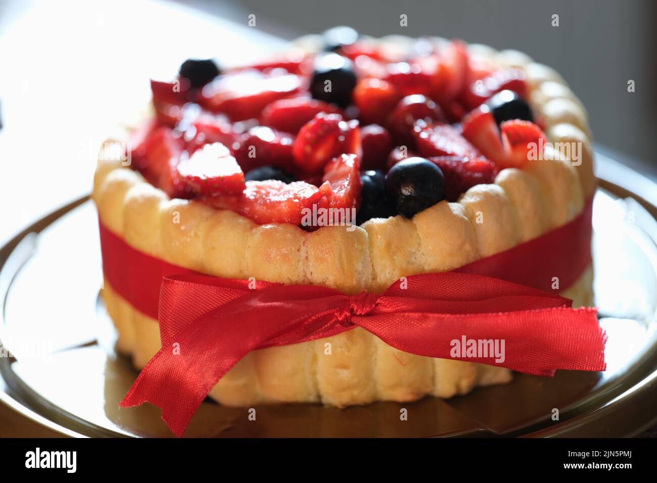 Fresh berry sweet fresh pie with red ribbon Stock Photo - Alamy