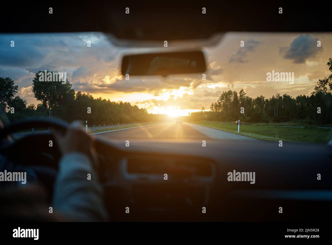 Driving car in summertime on the sunset Stock Photo Alamy
