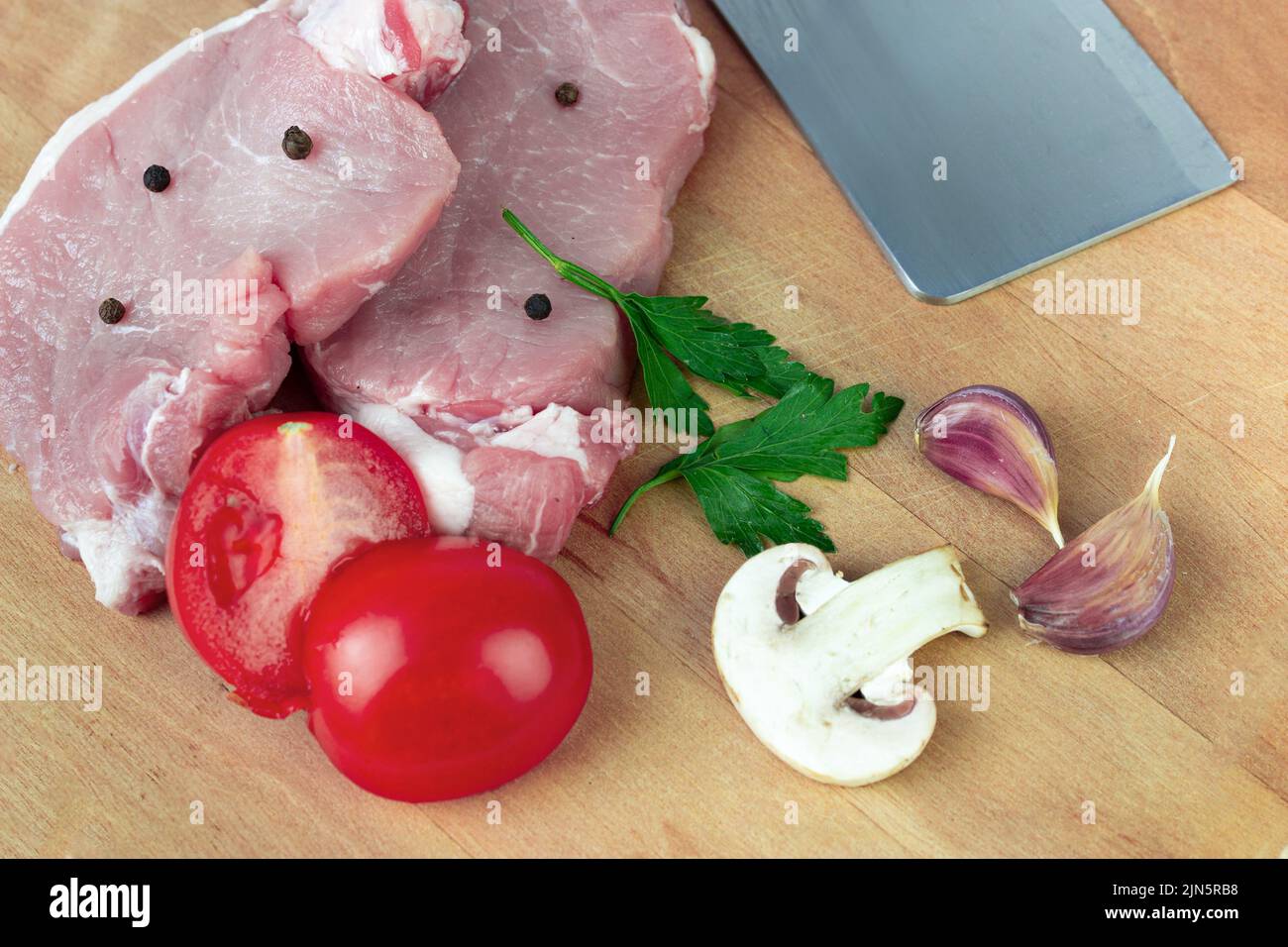 Raw meat. Fresh meat ready to cook with Ingredient - garlic, tomato, spice, pepper, champignon. Cooking concept Stock Photo