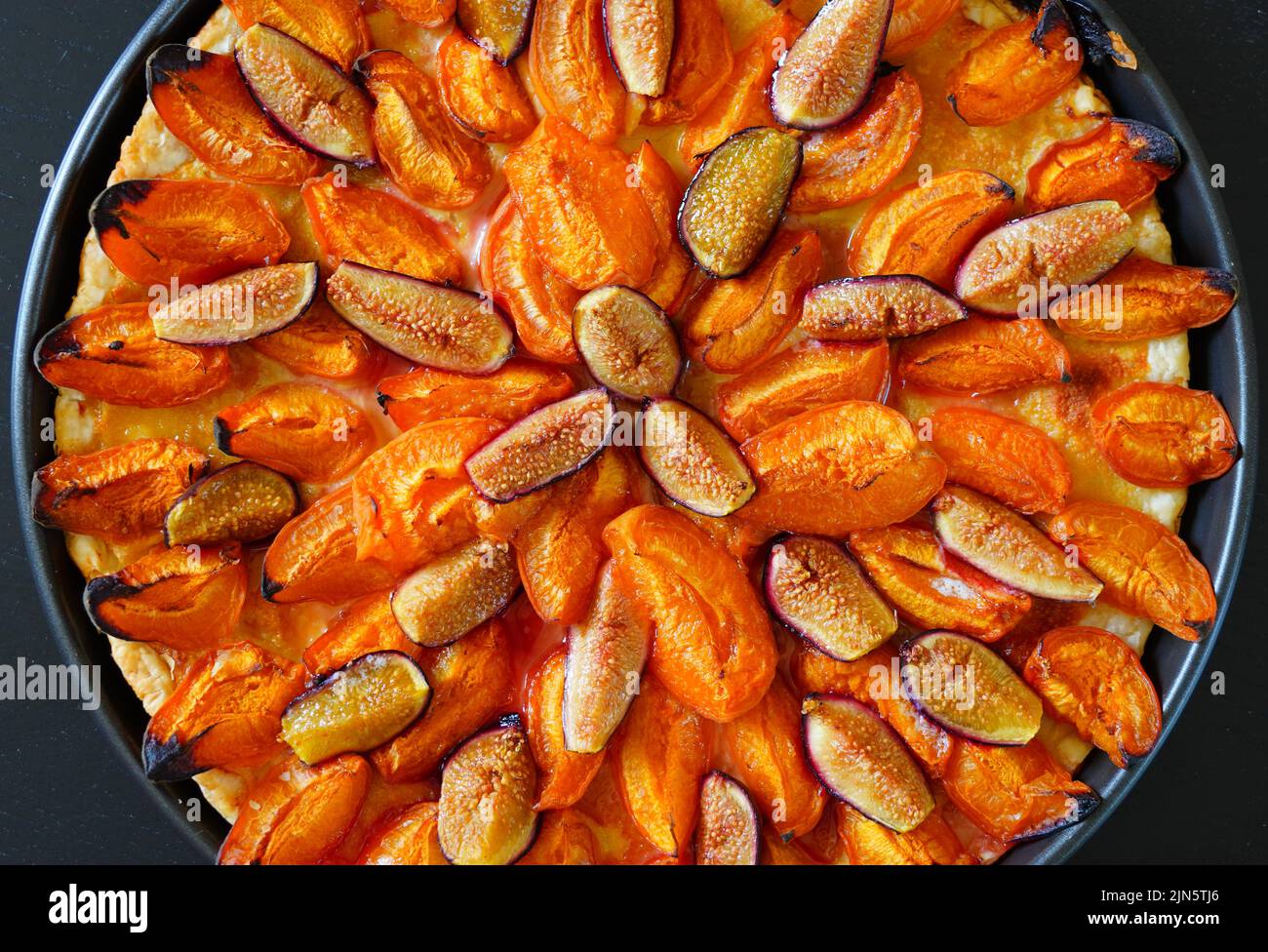 Homemade tart with apricots, figs and almonds Stock Photo