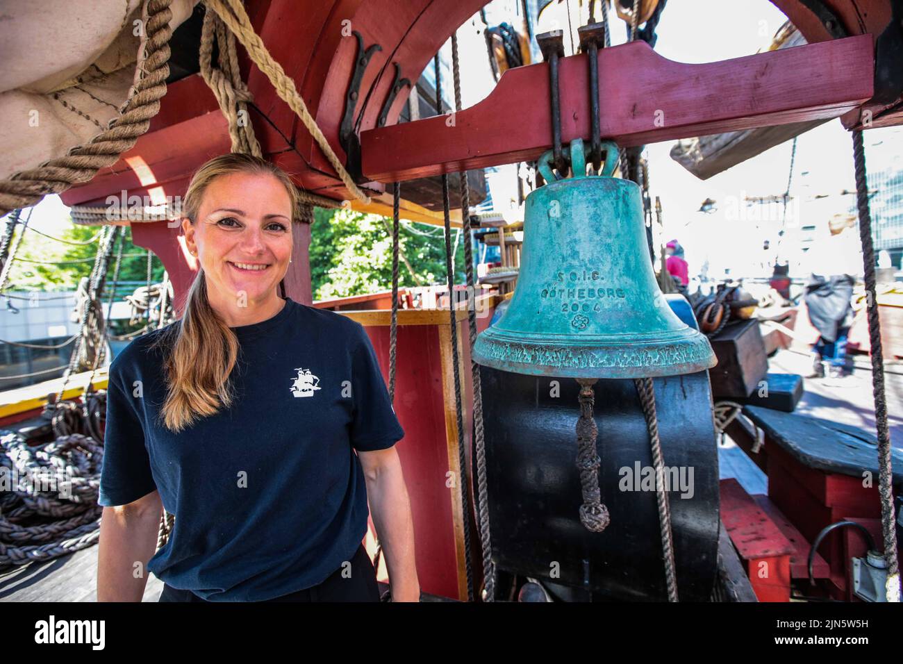 London UK 9 August 2022 Anna Creutz crew member next to the ship bell which according to tradition ,in Sweden,is unlucky to ever clean it . Open to visitors every day until 12 of August  Paul Quezada-Neiman/Alamy Live News Stock Photo