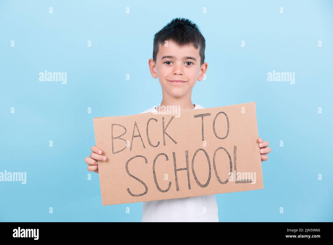 a boy holds a back-to-school poster Stock Photo