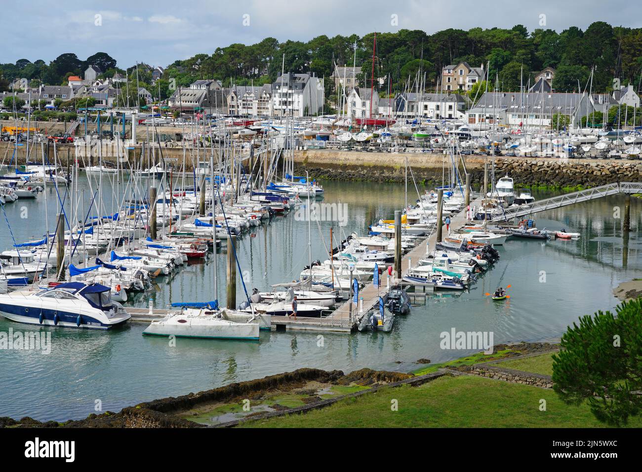 LA-TRINITE-SUR-MER, FRANCE -9 AUG 2021- View of boats in the harbor of La Trinite sur Mer, a pleasure boats harbor on the Bay of Quiberon in Morbihan, Stock Photo