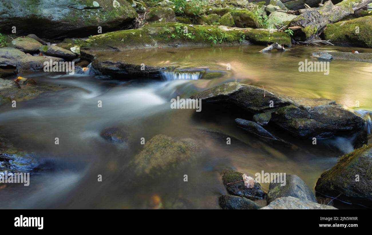 Stream running fast over moss covered rocks near Boone North Carolina. Stock Photo