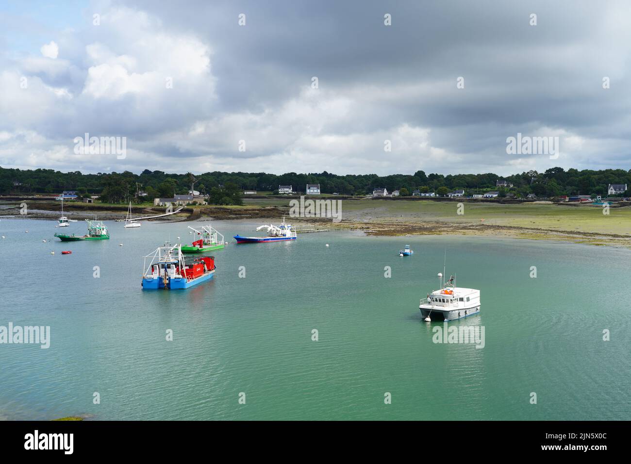 LA-TRINITE-SUR-MER, FRANCE -9 AUG 2021- View of boats in the harbor of La Trinite sur Mer, a pleasure boats harbor on the Bay of Quiberon in Morbihan, Stock Photo
