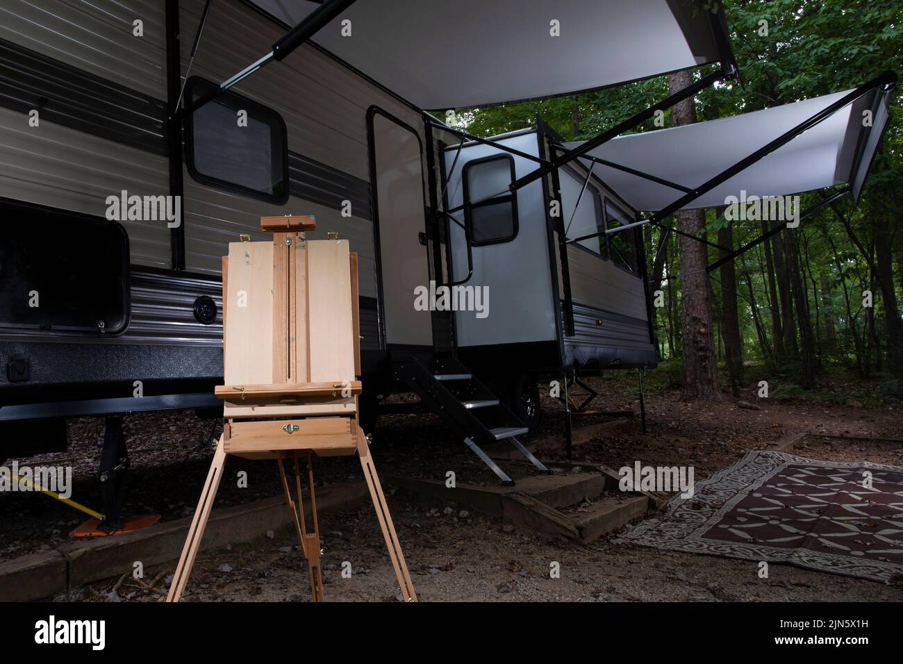 Travel trailer at Falls Lake with an easel at the campsite Stock Photo