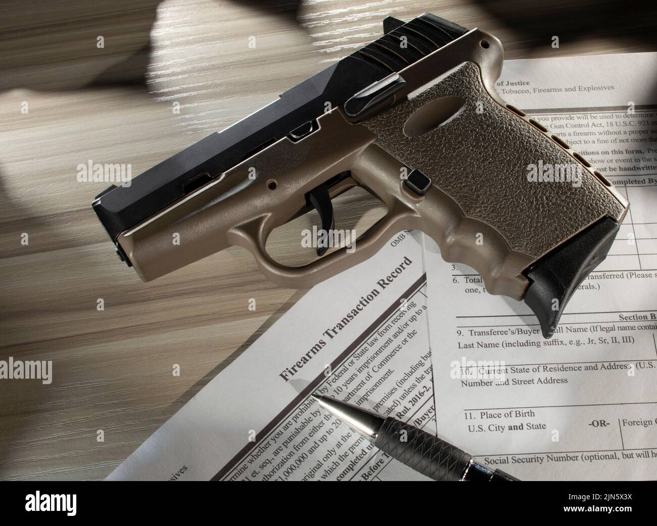 Semi automatic pistol with public domain transfer form and pen Stock Photo