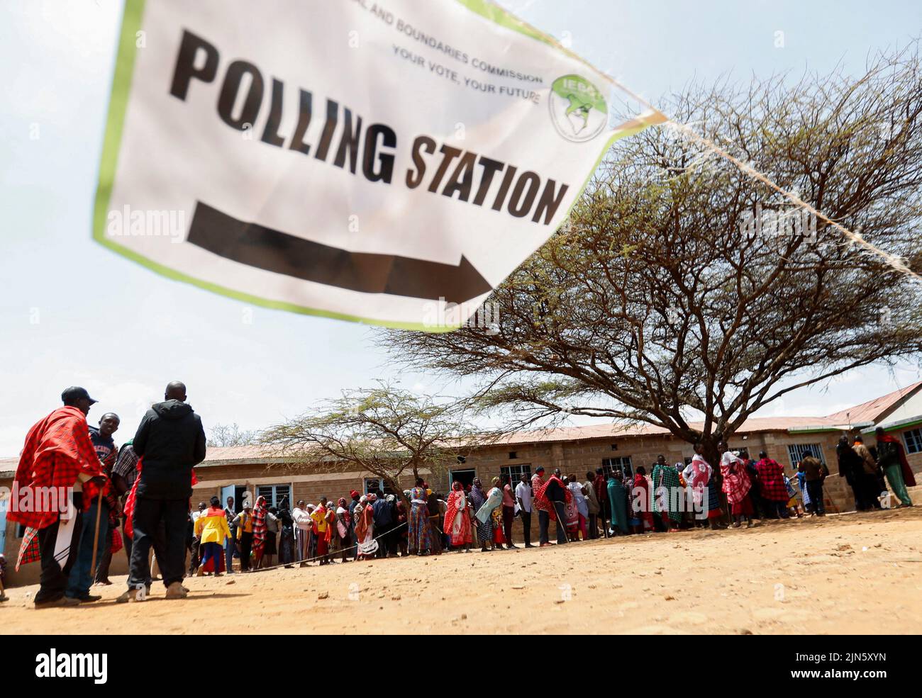 Maasai traditional people queue at a polling centre before casting their ballots during the general election by the Independent Electoral and Boundaries Commission (IEBC) in Ewaso Kedong primary school, in Kajiado county, Kenya August 9, 2022. REUTERS/Thomas Mukoya Stock Photo
