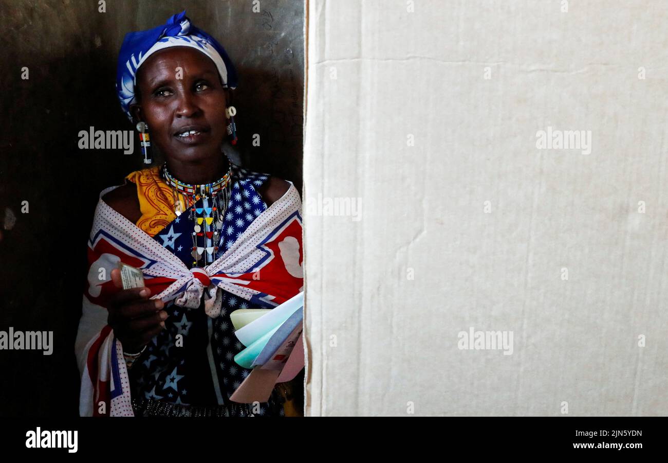 A Maasai traditional woman stands inside a voting booth at a polling centre after casting her ballot during the general election by the Independent Electoral and Boundaries Commission (IEBC) in Ewaso Kedong primary school in Kajiado county, Kenya August 9, 2022. REUTERS/Thomas Mukoya Stock Photo