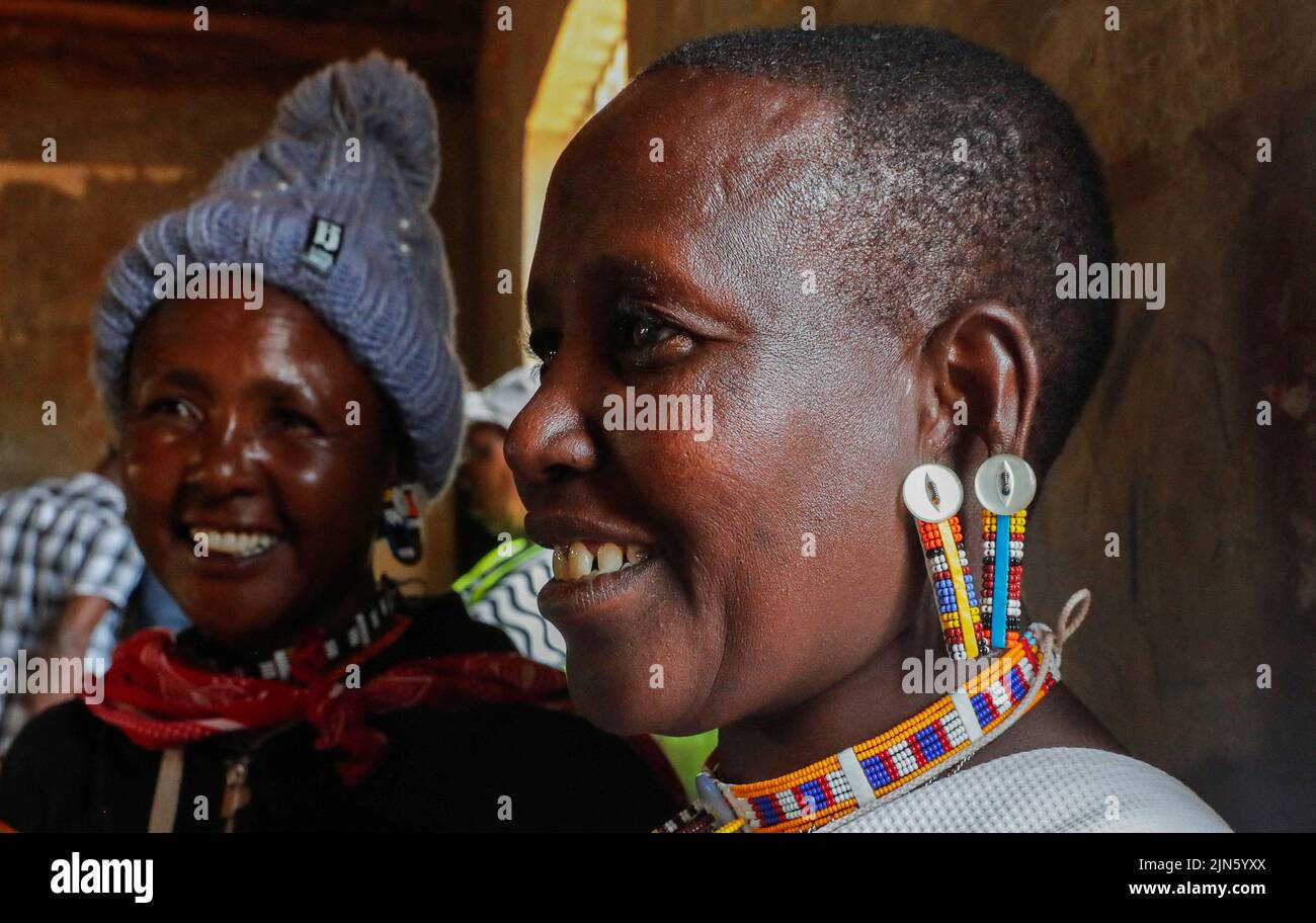 Maasai traditional women are stand near a voting booth at a polling centre after casting their ballots during the general election by the Independent Electoral and Boundaries Commission (IEBC) in Ewaso Kedong primary school in Kajiado county, Kenya August 9, 2022. REUTERS/Thomas Mukoya Stock Photo