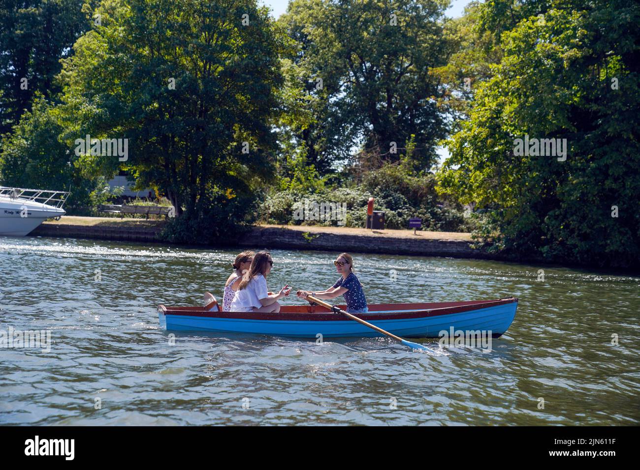 People row a boat on the River Thames in Windsor, as a summer of hosepipe bans and fire warnings continues, with a heat health alert coming into place across much of the country. Picture date: Tuesday August 9, 2022. Stock Photo