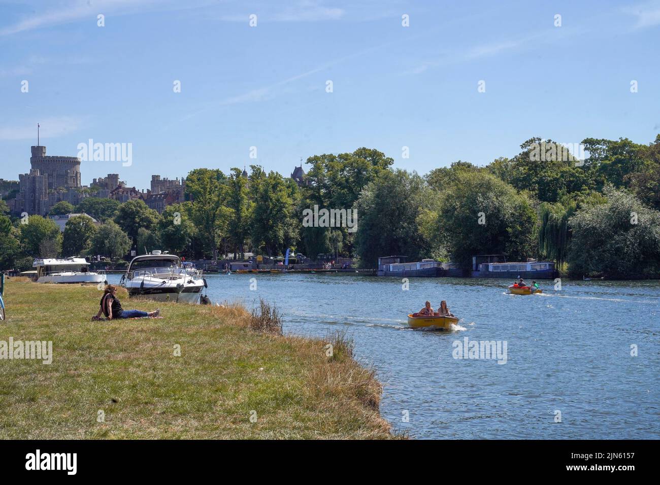 People on a boat on the River Thames in Windsor, as a summer of hosepipe bans and fire warnings continues, with a heat health alert coming into place across much of the country. Picture date: Tuesday August 9, 2022. Stock Photo