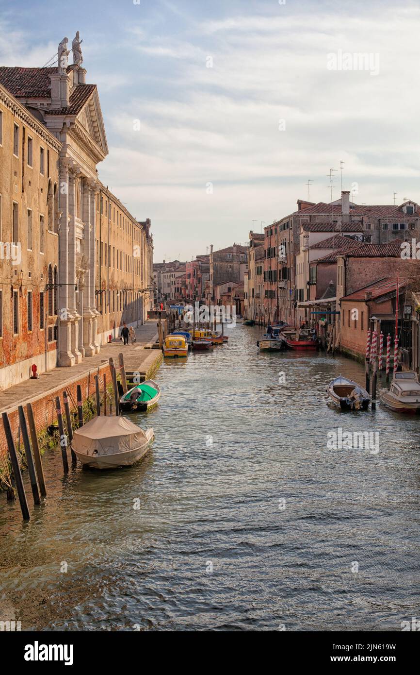 One of the many beautiful canals in Venice, Italy with boats Stock Photo
