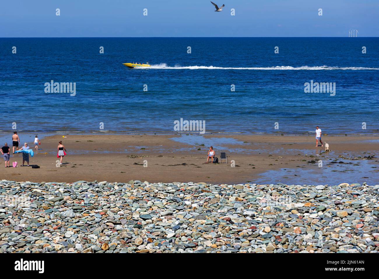Beach scene with speedboat at Llandudno. Stock Photo