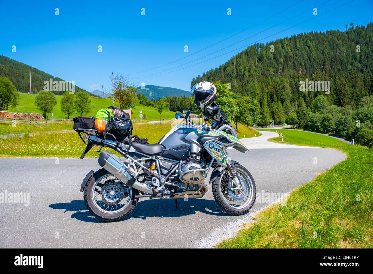 Dolomites Italy - July 2, 2022: Motorcycle with full equipment on the side of a rural mountain alpine road in area of Dolomites, Italy Stock Photo