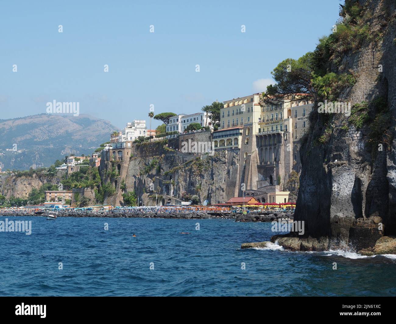 Sorrento seen from Marina Grande, Campania, Italy. The town itself is built on high and very steep cliffs, there is no beach but people use piers buil Stock Photo