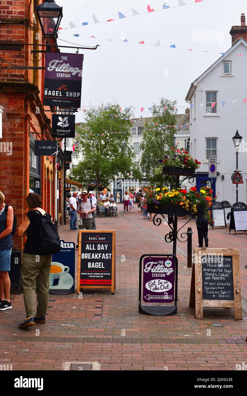 A view along Old Fore Street in Sidmouth town centre with people