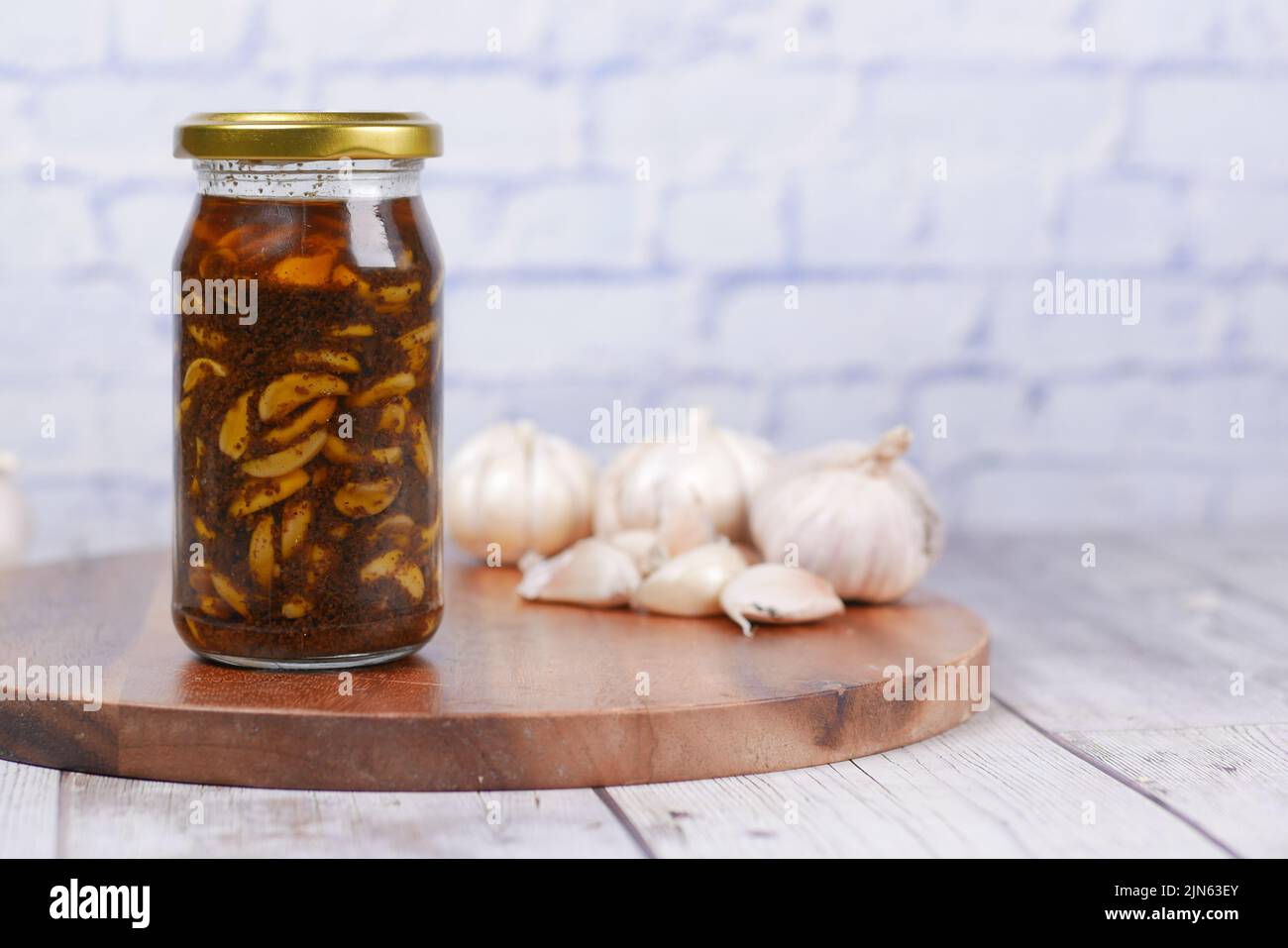 Homemade Garlic Pickle in a glass jar on table , Stock Photo