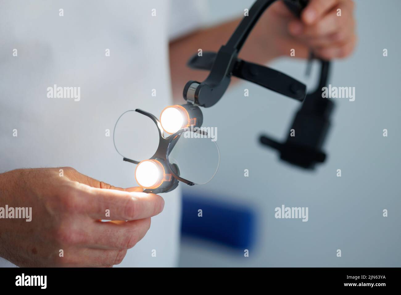 Dentist doctor holding the binocular loupes Stock Photo Alamy