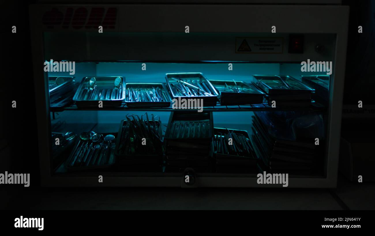 Dental instruments are sterilized in a autoclave under an ultraviolet