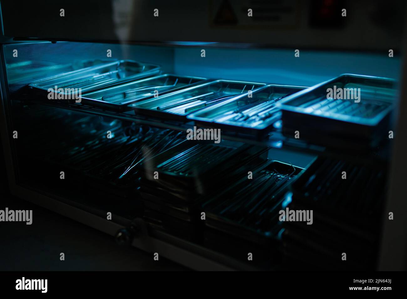 Steel dental instruments lying in a sterilizer under ultraviolet Stock