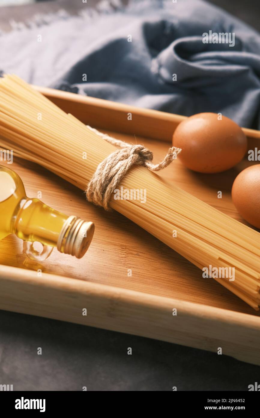 Yellow long spaghetti egg and oil on table  Stock Photo