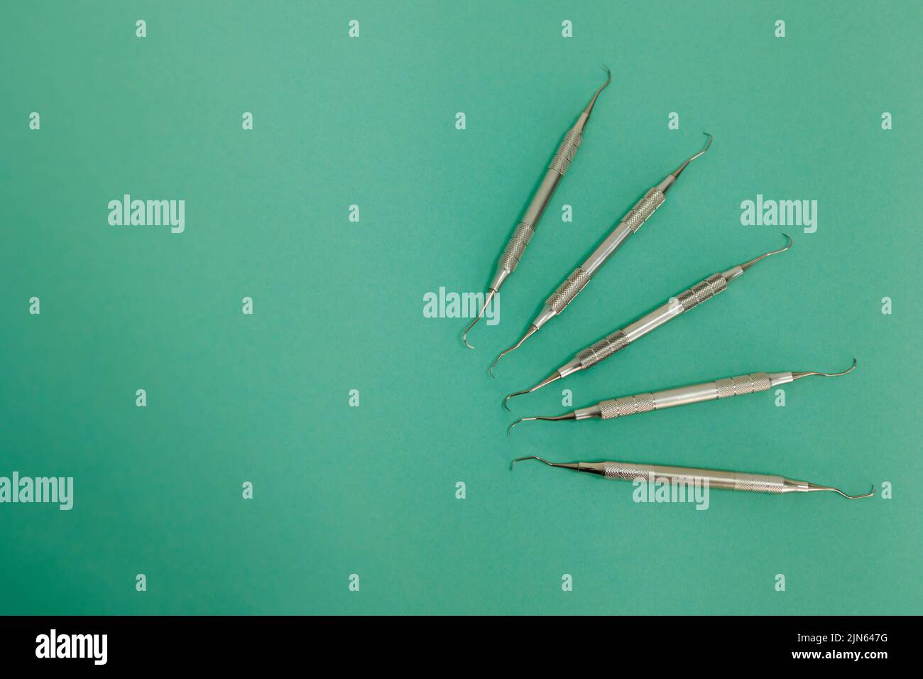 Lot Of Dental Periodontal Scalers On Green Background Stock Photo - Alamy