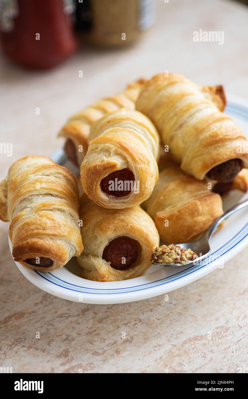 Pigs in a blanket mini sausage roll on a plate Stock Photo Alamy