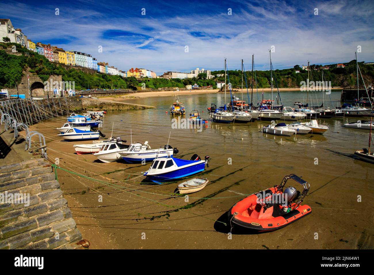 The picturesque sheltered harbour is overlooked by rows of colourful houses in Tenby, Pembrokeshire, Wales, UK Stock Photo