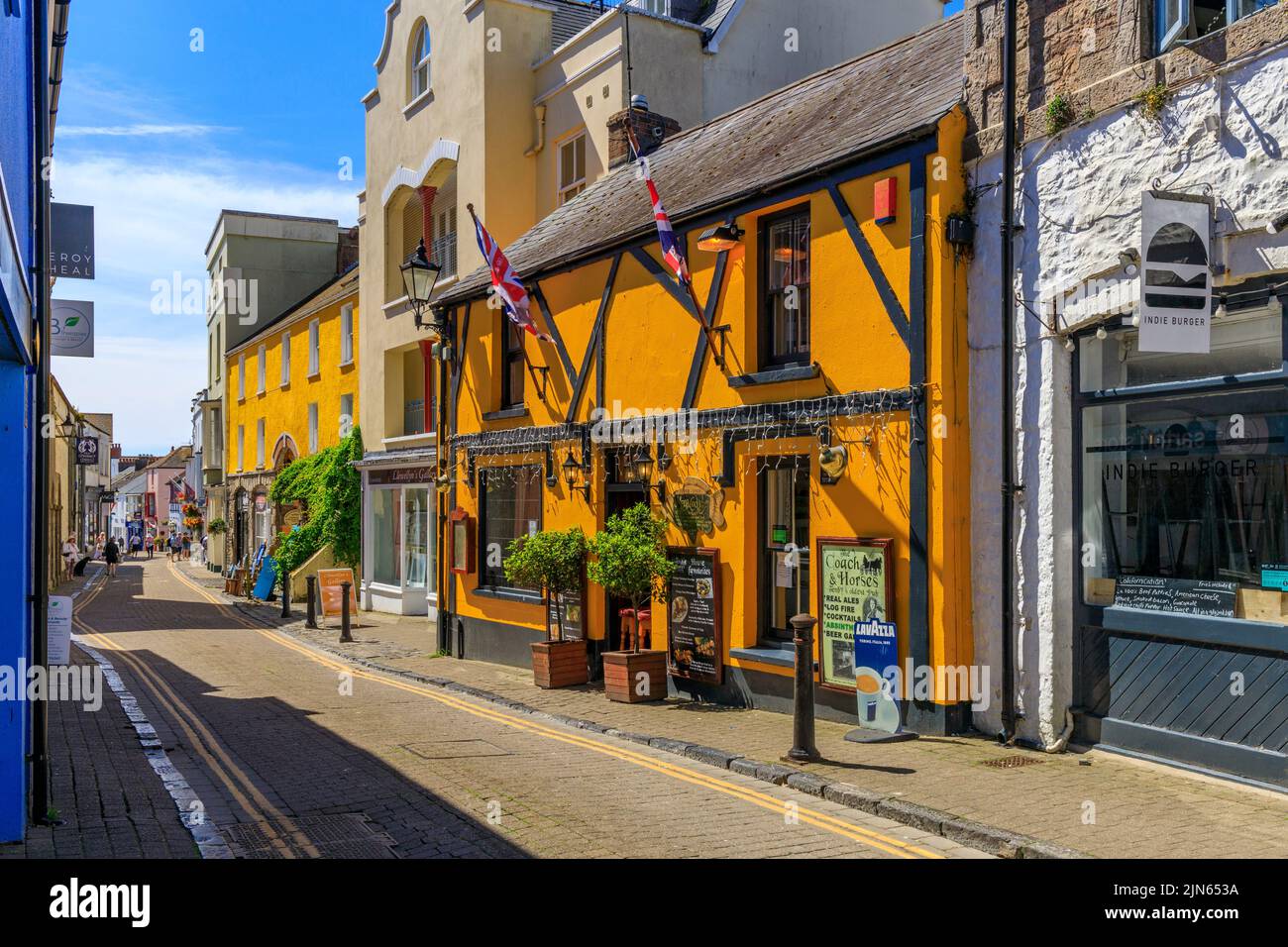Colourful shops and pubs in Upper Frog Street, Tenby, Pembrokeshire, Wales, UK Stock Photo