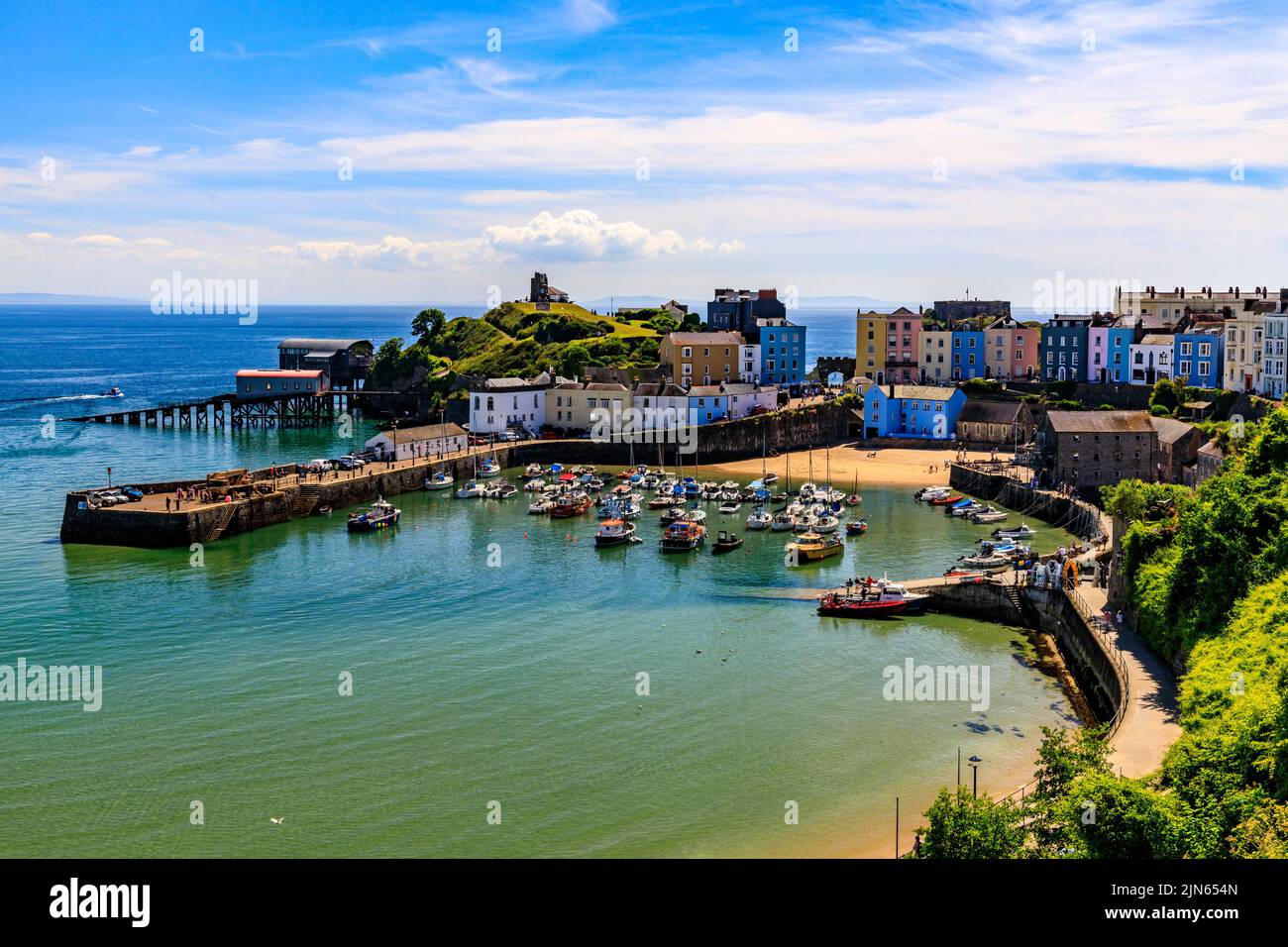 The picturesque sheltered harbour is overlooked by rows of colourful houses in Tenby, Pembrokeshire, Wales, UK Stock Photo