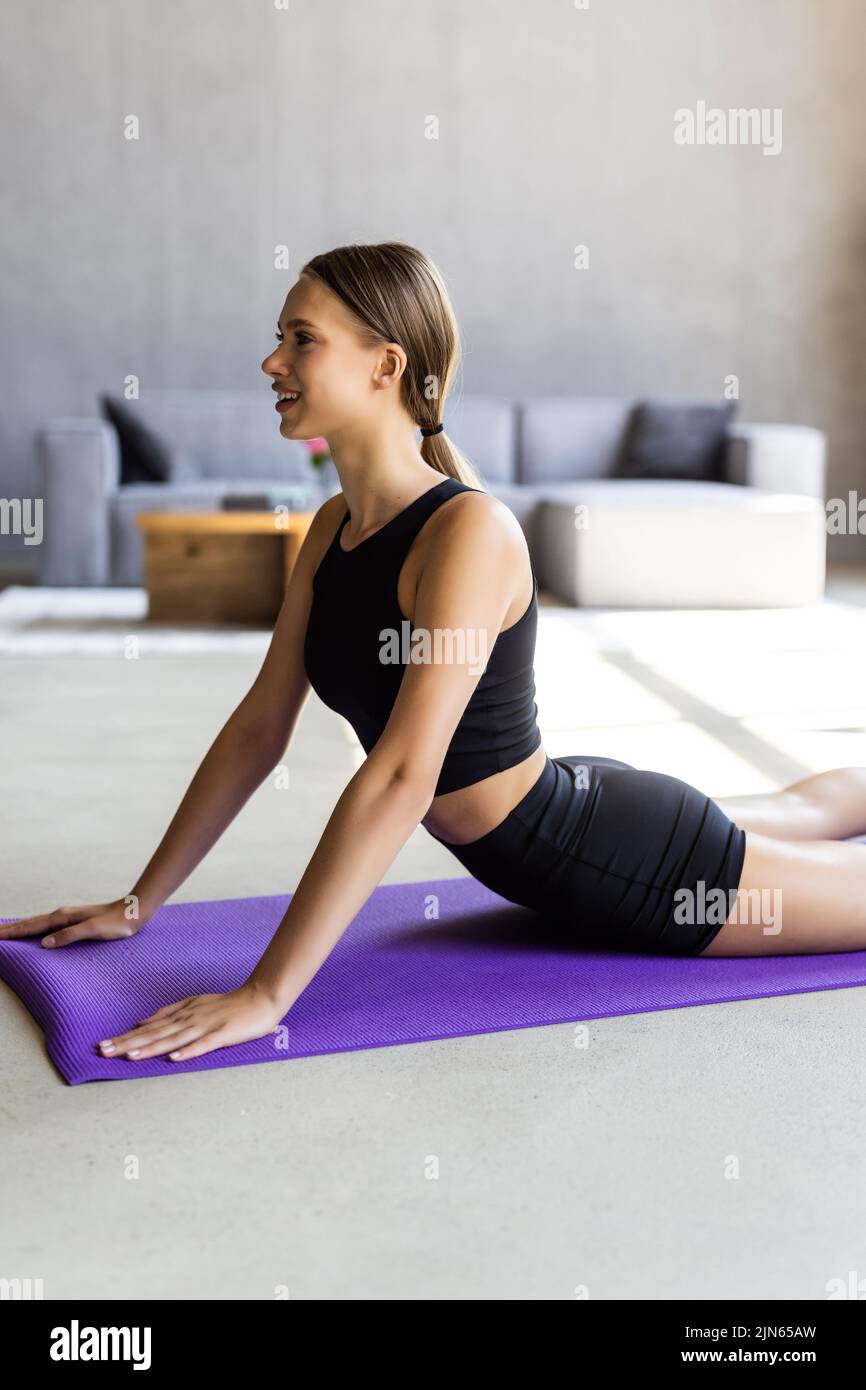 Yoga Meditation Cobra Stretch Woman Home Health Wellness Flexibility  Exercise Stock Photo by ©PeopleImages.com 647390622