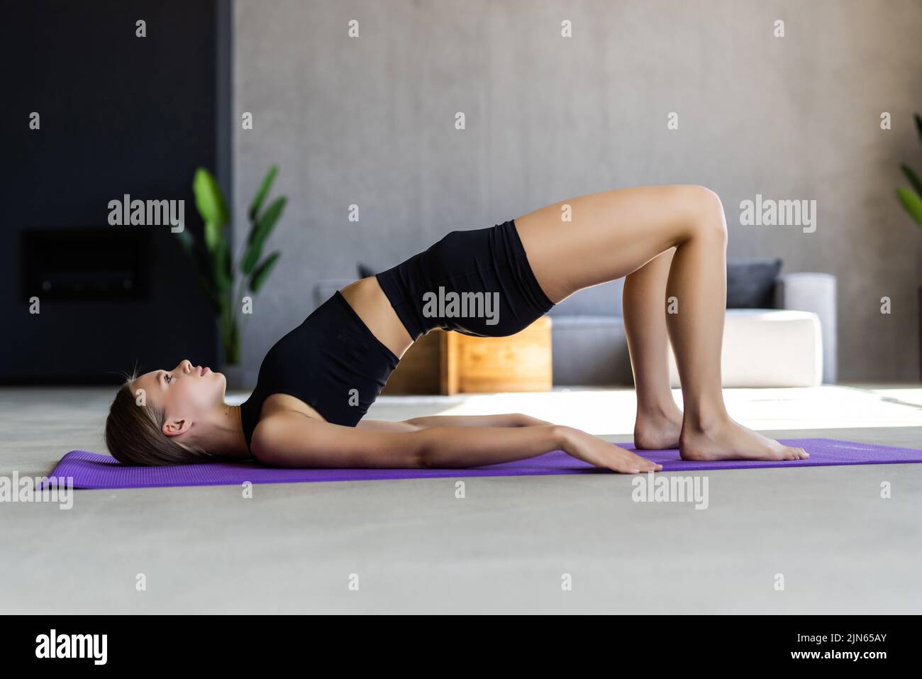 Fitness young woman doing plank corp exercise at home Stock Photo