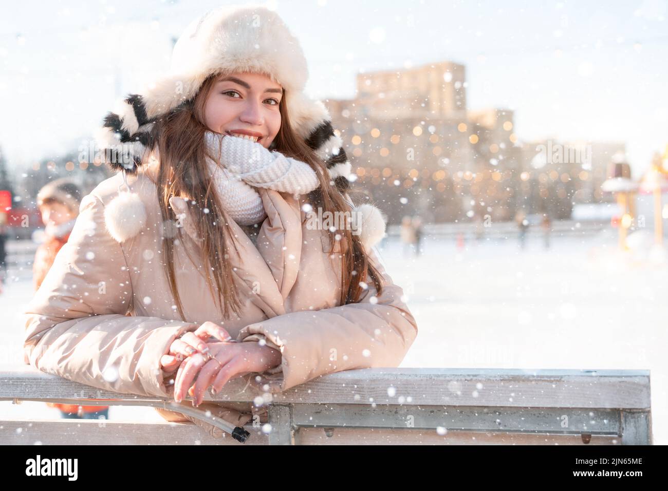 Beautiful lovely young woman long hair warm winter jackets funny fluffy hat stands outdoor on city street. Christmas mood lifestyle Happy holiday woma Stock Photo
