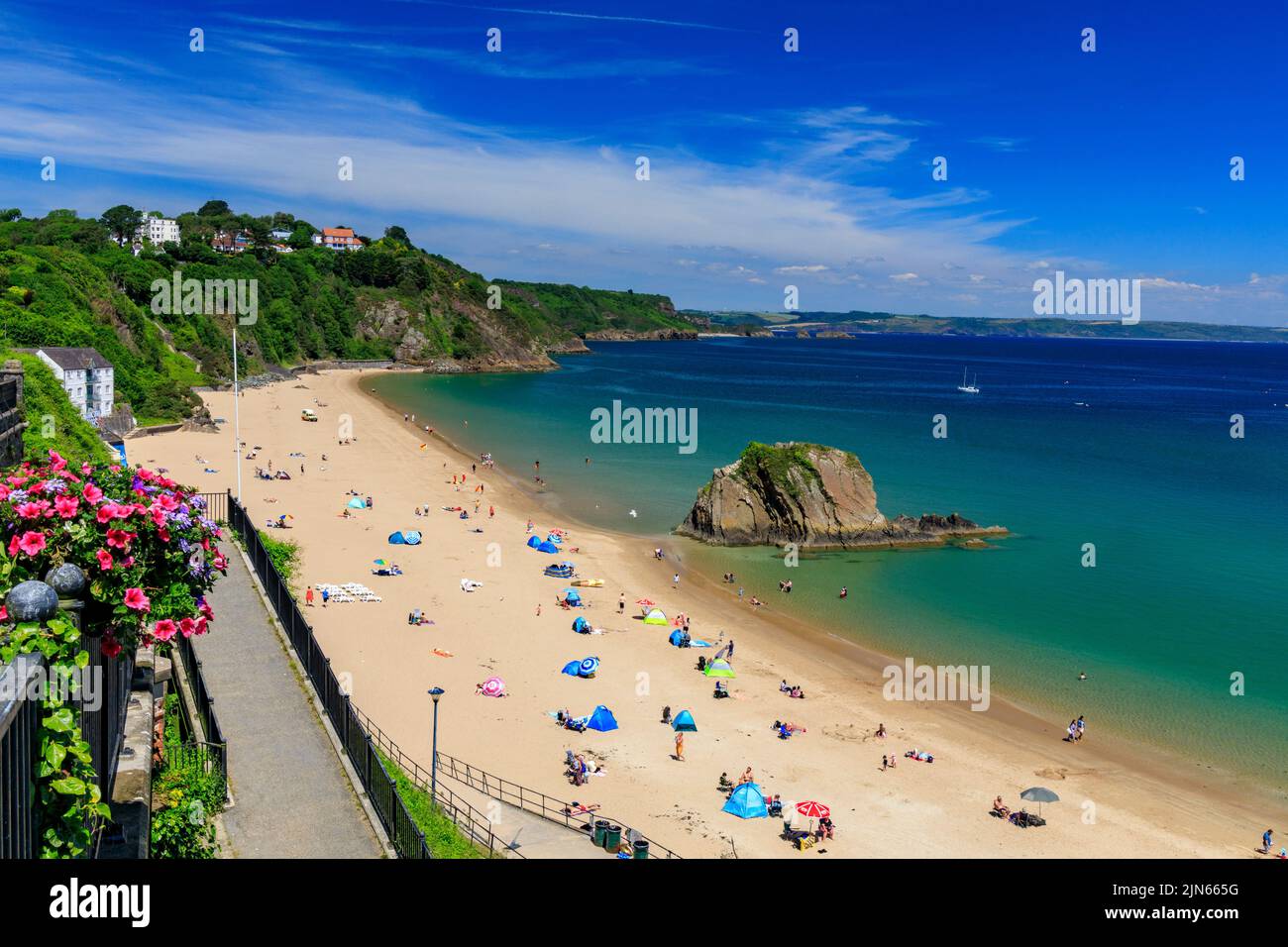 The sandy North Beach with the imposing Goscar Rock in in Tenby, Pembrokeshire, Wales, UK Stock Photo