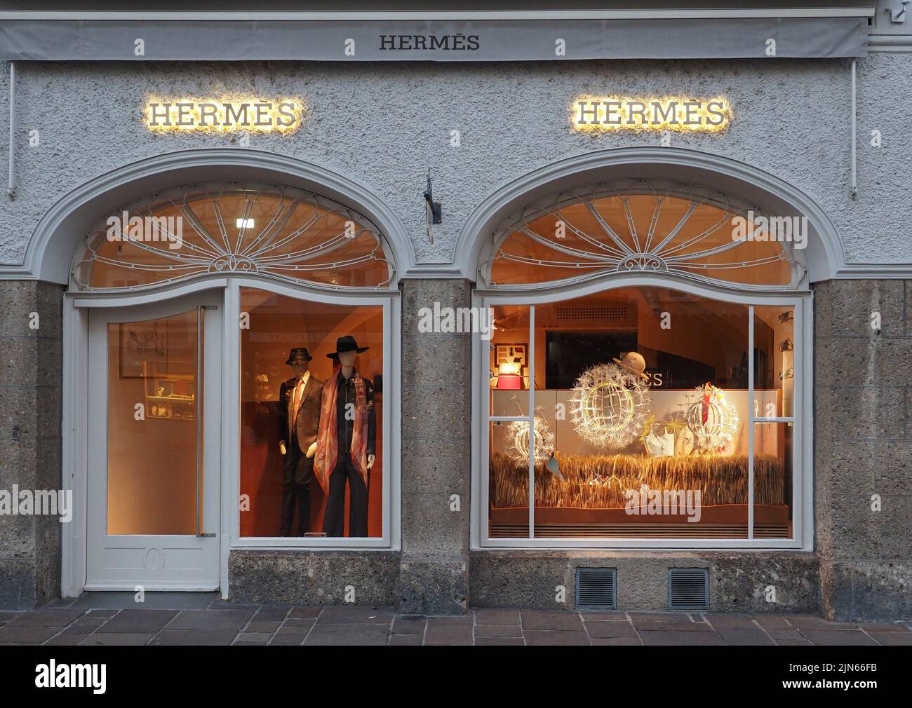 Luminous shop windows of the Hermes boutique in the center of Salzburg. Stock Photo