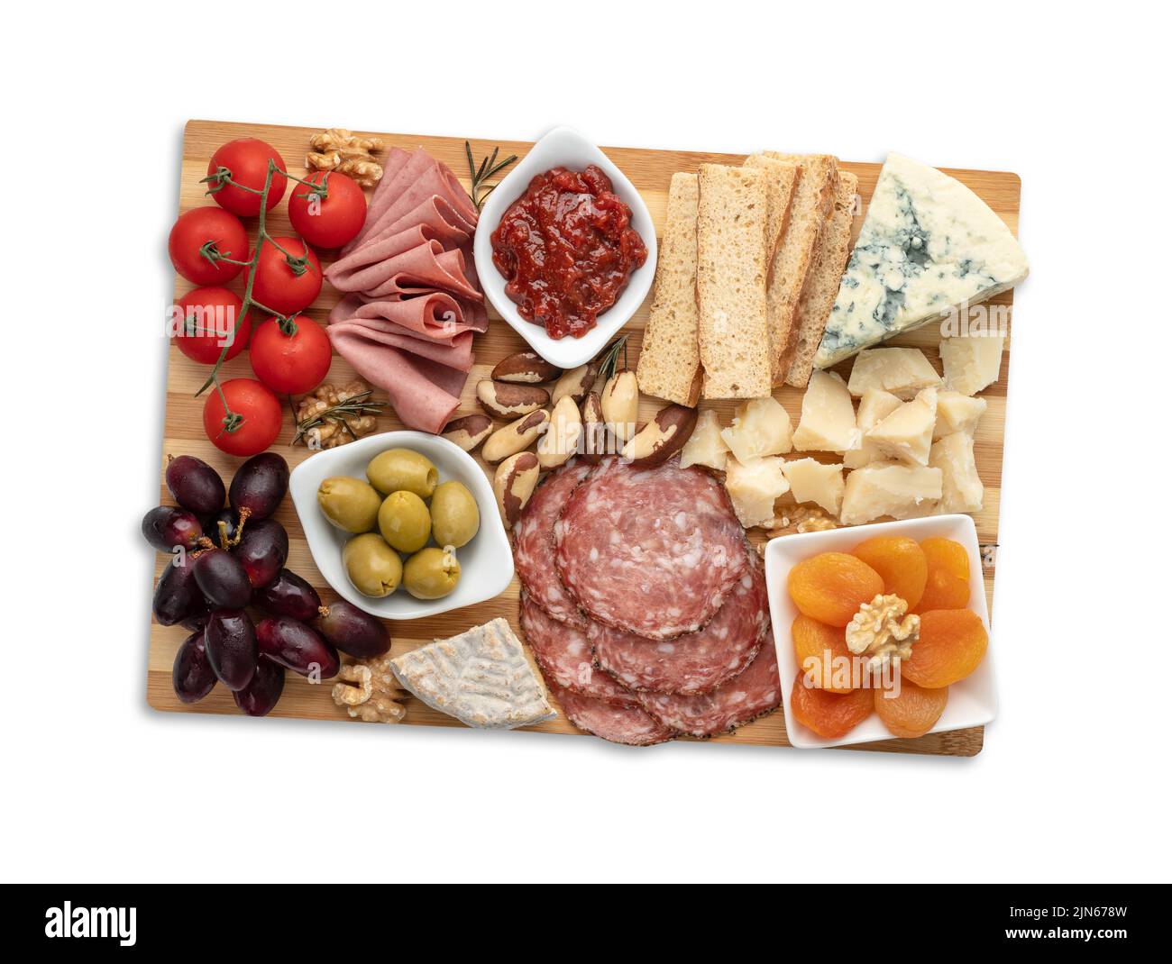 Appetizer board with cheese, nuts, fruits, toasts and charcuterie isolated over white background. Stock Photo