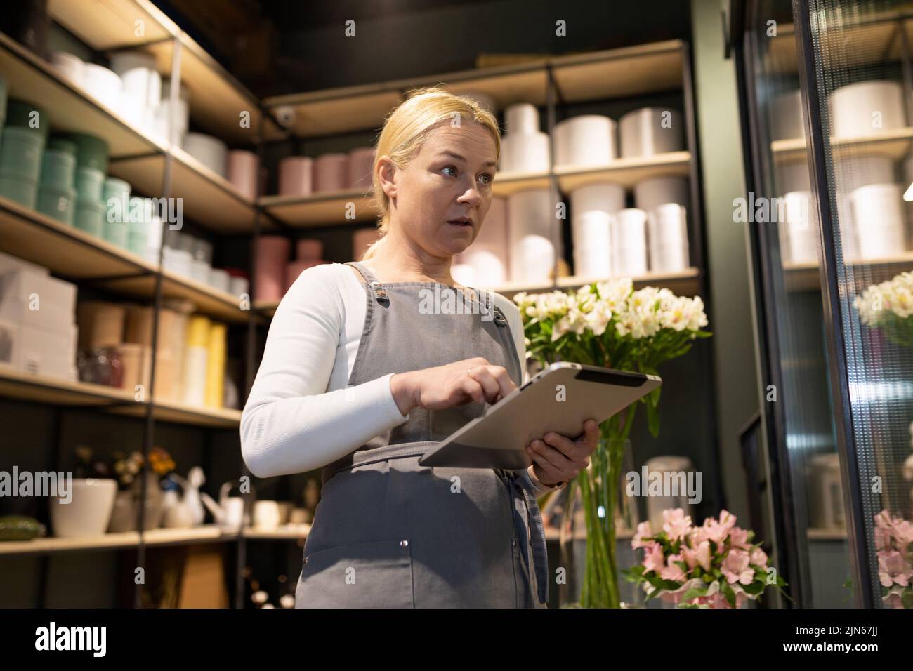 flower shop employee doing inventory in warehouse Stock Photo Alamy